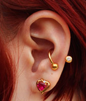 Conch Piercing with Gold Twister Barbell